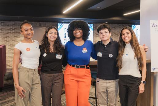 Group of students and Chaiken Center staff member with arms around each other at an event.