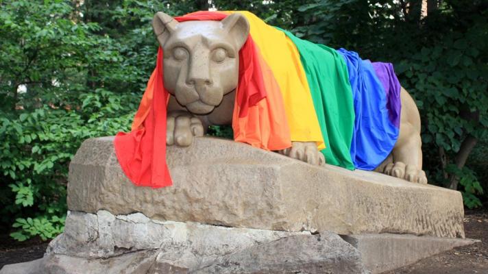 Lion shrine draped in a rainbow flag