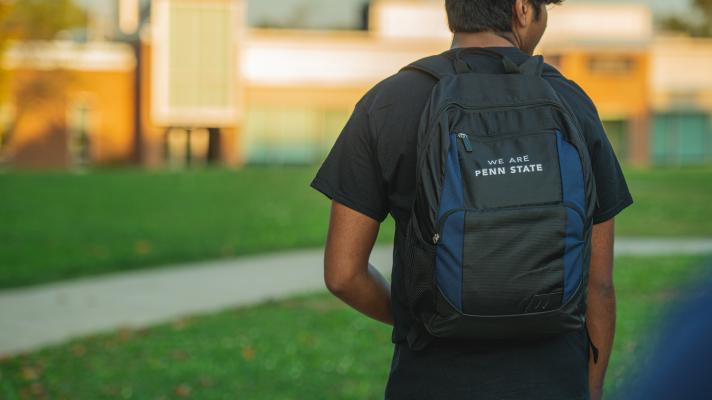 Back of student's backpack that says "We Are Penn State"