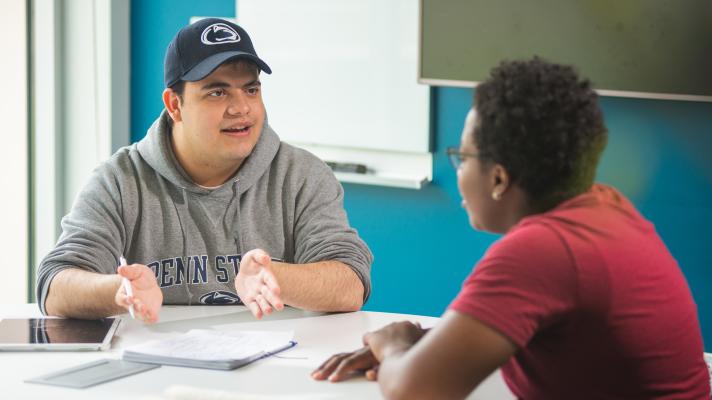 Students sitting at table having a discussion