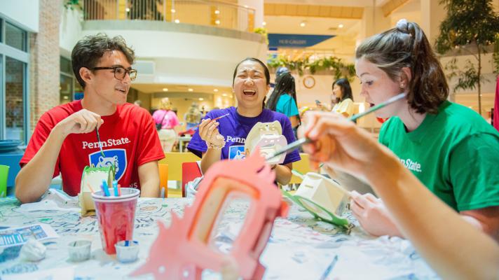 Students laughing while doing a craft